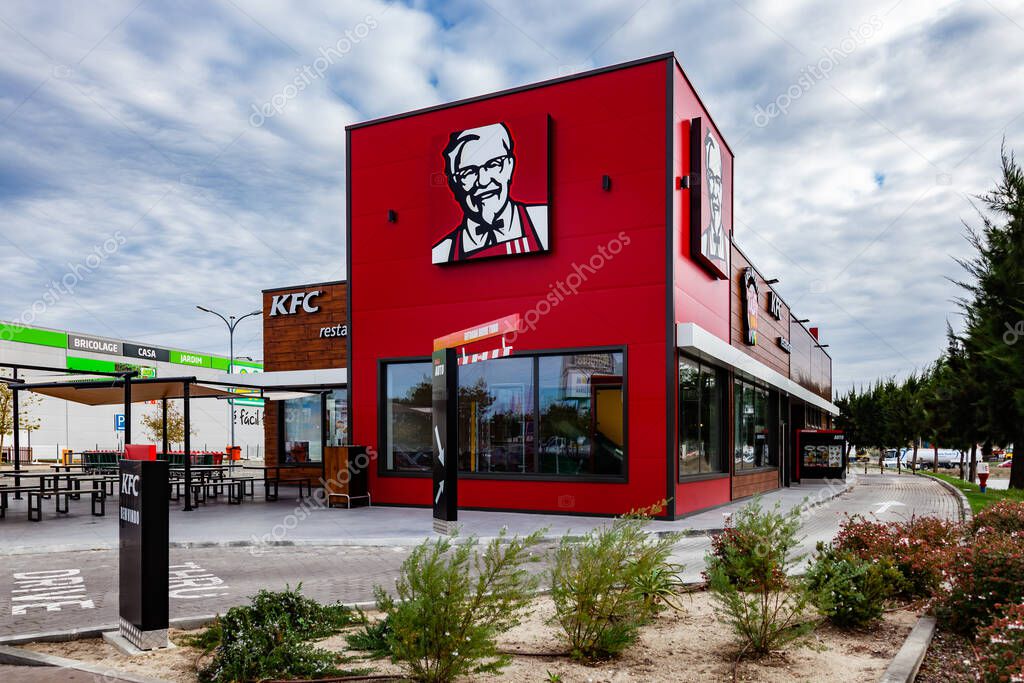 Coina, Portugal - October 23, 2019: KFC fast food restaurant with outdoor seating and Drive Thru. Kentuky Fried Chicken junk food in Barreiro Planet Retail Par