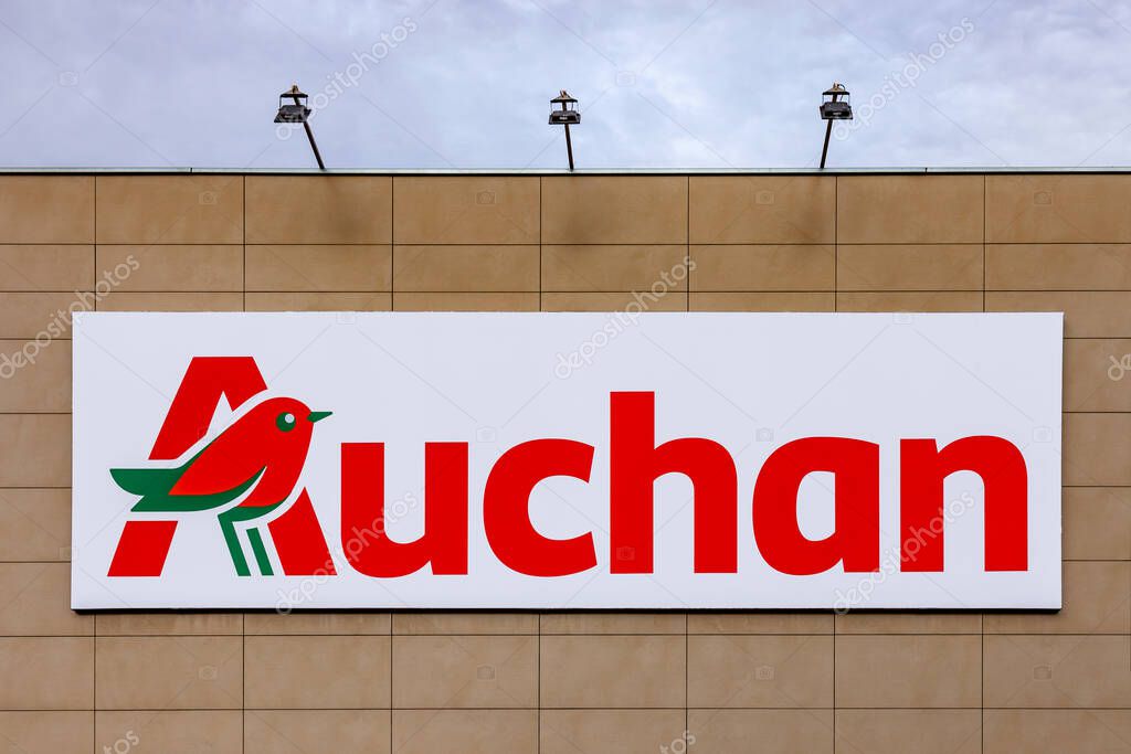 Coina, Portugal - October 23, 2019: Auchan logo or symbol in the Barreiro Planet Retail Park. Auchan is a French hypermarket, supermarket or superstore chai