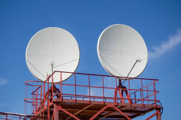 Satellite dish of digital television broadcasting against the blue sky.