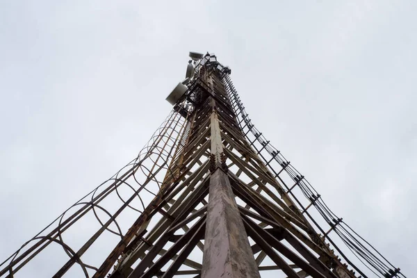 Telephone tower. Metallic cellular tower, bottom view.