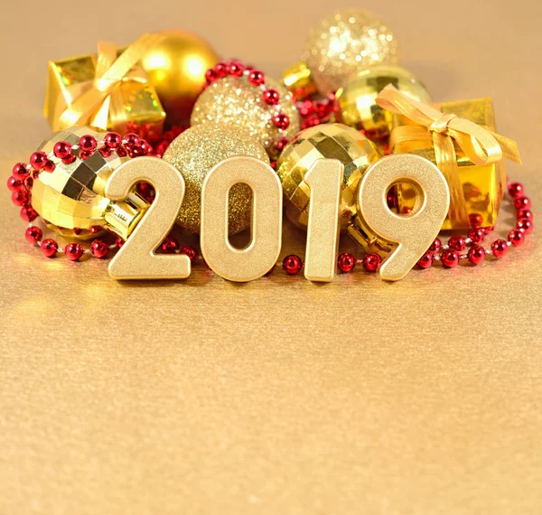 2019 year golden figures on the background of golden and red Christmas decorations