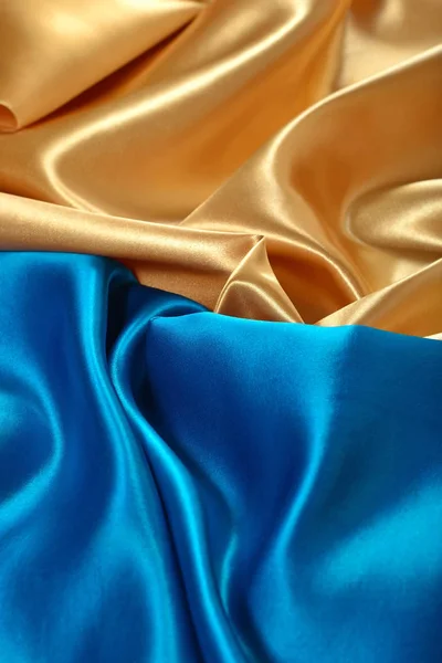 Natural golden and blue satin fabric as background texture