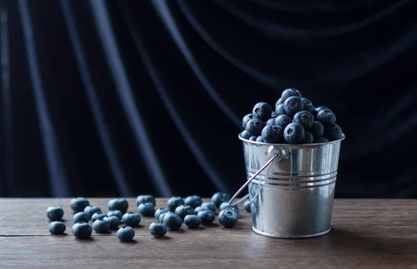 blueberries in a metal bucket in the evening