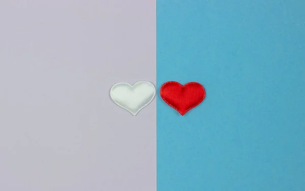 two white and red hearts on two sides of the background. Valentine's Day and International Women's Day