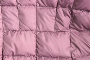 Tekstil ve doku kavramı-kırılmış pembe kumaş arka plan closeup