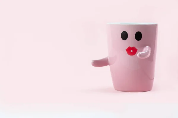 Happy friday word. Cup of coffee on pink background with smile face on mug. Concept about love and relationship. Creative colorful greeting card