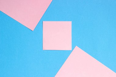 Renkli kağıttan soyut geometrik düz arka plan. Pembe ve mavi renkli kağıt, metin eklemek için bir şablon.
