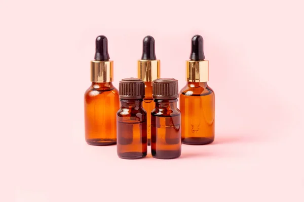 A set of amber bottles for essential oils and cosmetics. Glass bottle. Dropper, spray bottle