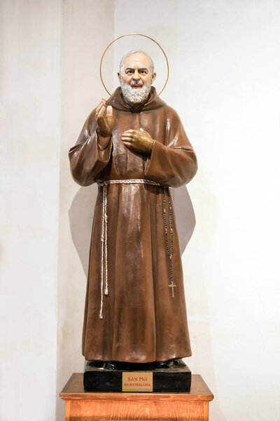 Statue of Padre Pio or Saint Pio of Pietrelcina, a Roman Catholic friar and priest who displayed Holy Stigmata throughout his life, with his hand raised in benediction