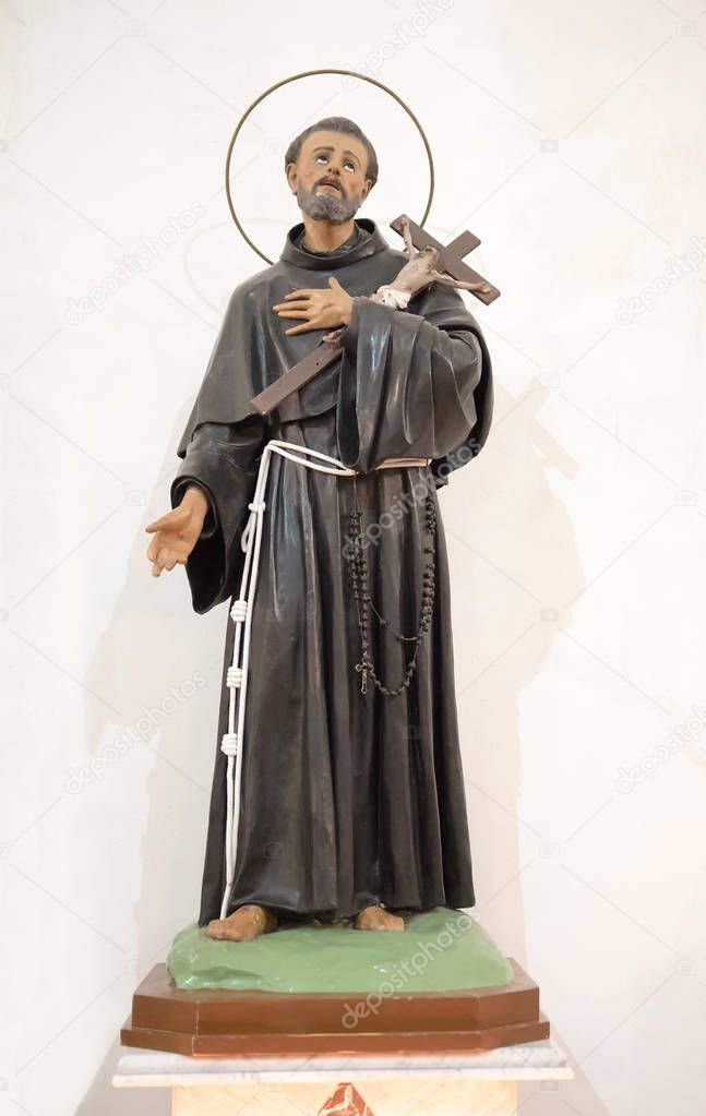 Religious Statue of Saint Francis of Assisi, patron saint of animals and nature and founder of the Franciscan Order over a white background