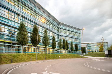 Yol dışında modern ofis binası mavi cam pencereler ile karmaşık.