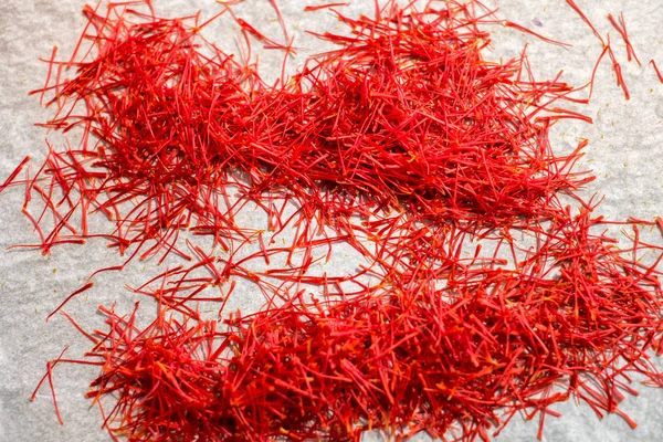 Two Piles Red Saffron Threads Viewed Grey Kitchen Table Surface — Stock Photo, Image