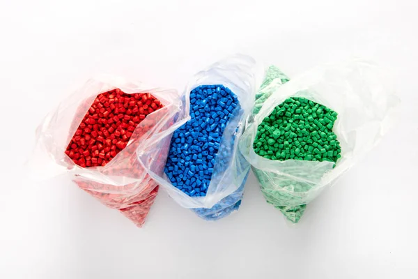 Bags Colorful Plastic Granules Red Blue Green Colors Viewed White — Stock Photo, Image