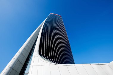 Zaha Hadid'in Milano İtalya'daki Generali Kulesi'nin çarpık tasarımının mimari detayı, binanın merkezi ekseninde büküldünü ve aşağıdan mavi bir gökyüzüne doğru baktığını