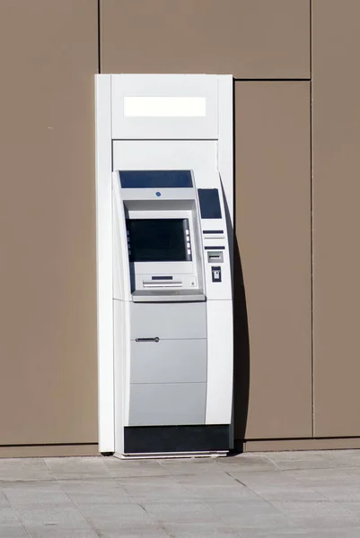 Automatic Bank Teller outside a bank building on the street for personal banking, withdrawing and depositing cash