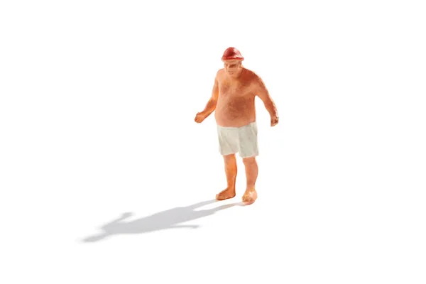 Obese miniature man in bathing trunks on beach — Stock Photo, Image