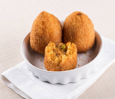 Arancini di Sicilia or fried stuffed rice balls clipart