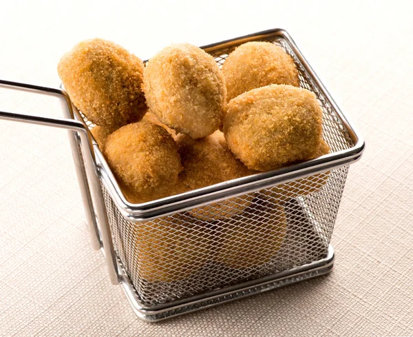 Wire frying basket filled with olive ascolane