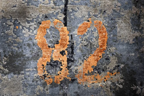 Rusty color 82 number on rough blue surface — Stock Photo, Image