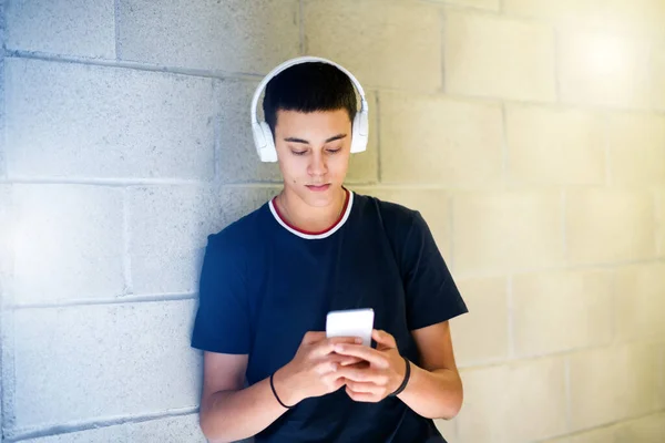 Young Teenage Boy Listening Music Headphones Browsing His Mobile Phone — Stock Photo, Image