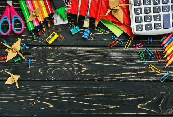 Back to school School stationery on a black wooden background — Stock Photo, Image