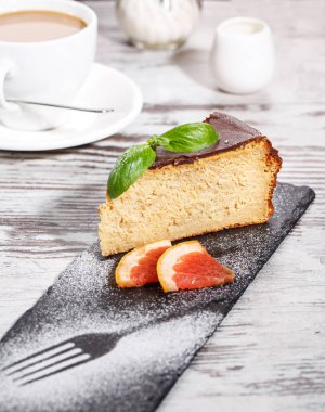 Bir parça kek yanında bir fincan kapuçino