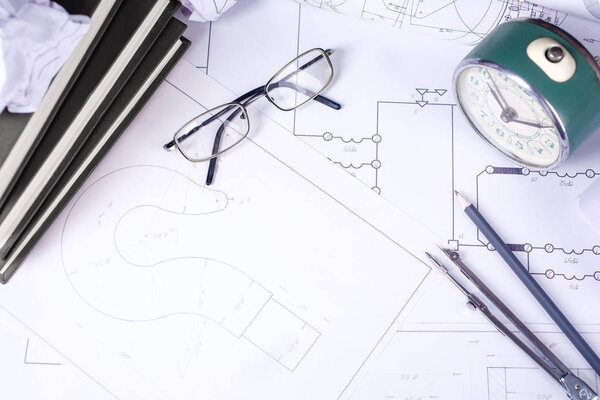 Rolls with drawings, design books and several drawing tools