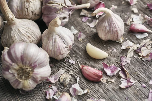 Garlic with husk on a wooden background