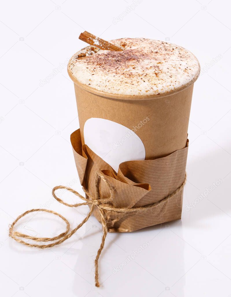 A Biodegradable Disposable Cup with blank white circle for text containing a hot drink on a white background with copy space.