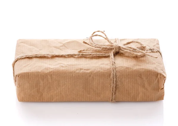 Parcel wrapped in brown kraft paper isolated on white background. — Stock Photo, Image