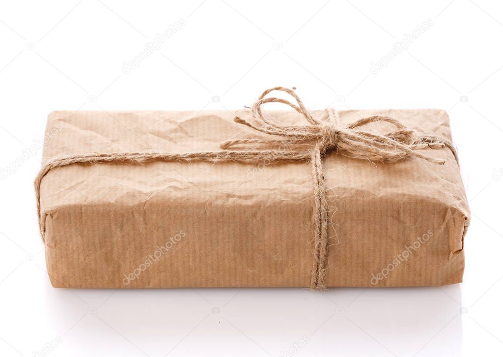 Parcel wrapped in brown kraft paper isolated on white background.