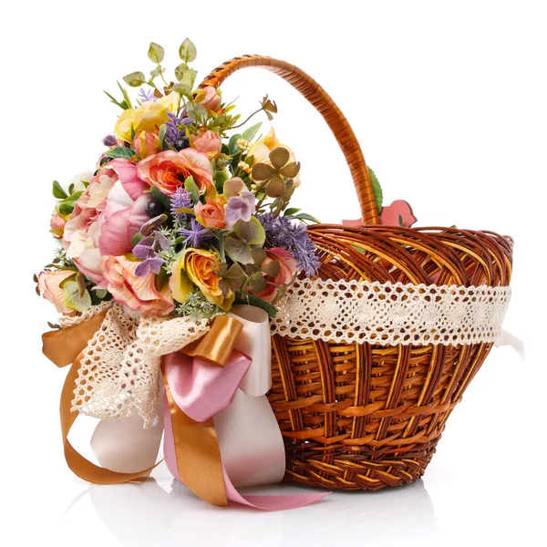 Provence Easter floral arrangement on a white wicker basket with a vine. Isolated. Ribbons and lace. — Stock Photo, Image