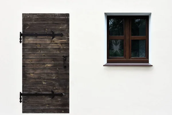 Simple picture of a door and a window on the white  wall