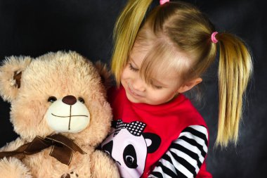 Bir balon bir çocukla bir oyuncak ayı oyuncak hugs ve üzücü ve mutlu