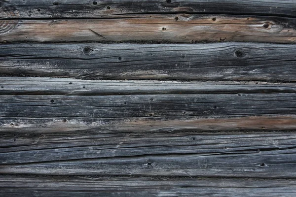 Bakgrunden konsistens av en vägg av gamla trä stockar och bräder — Stockfoto