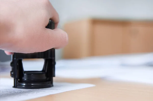 The manager puts a stamp on the document in the office, only hand, copy space — Stock Photo, Image
