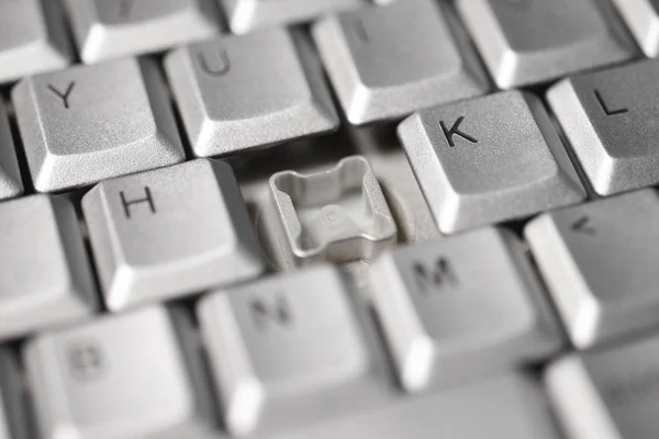 Broken button on a computer keyboard, close-up