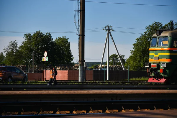 Railway worker checks the way in front of the train