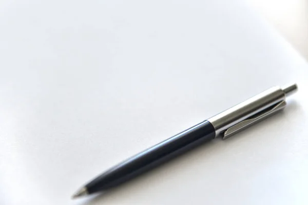 Pen on a white sheet of paper on the table — Stock Photo, Image