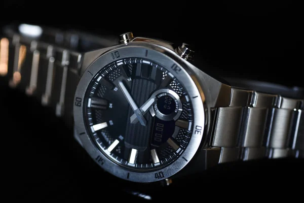 Luxury quartz watch with analog hands and a digital display and a solar battery, tachometer