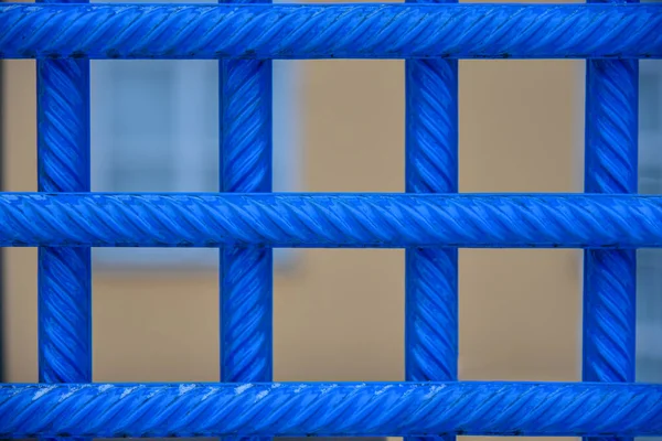 Painted blue iron bars in prison.