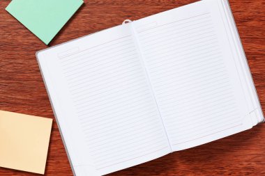 Not defteri, kağıt, kalem, çalışma için kalem veya ofisinde çalışacağım. Ahşap arka plan üzerinde izole.