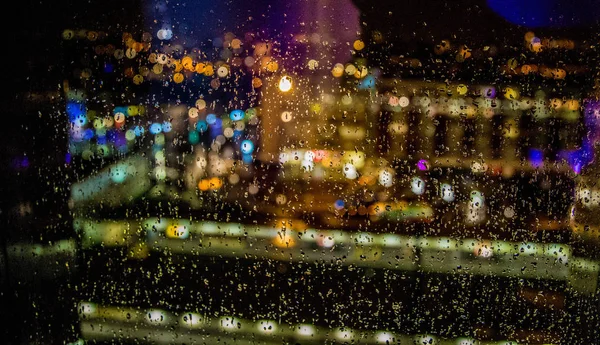 wet window, colored lights and drops of water