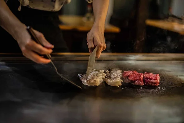 teppan show in a Japanese restaurant, cooking directly in front of the client, fish, rice, meat, vegetables