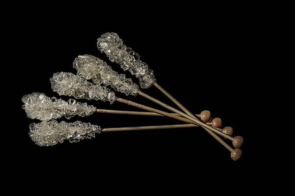 Brown cane sugar, cube sugar and crystalic sugar on wooden sticks isolated on white background. Top view.