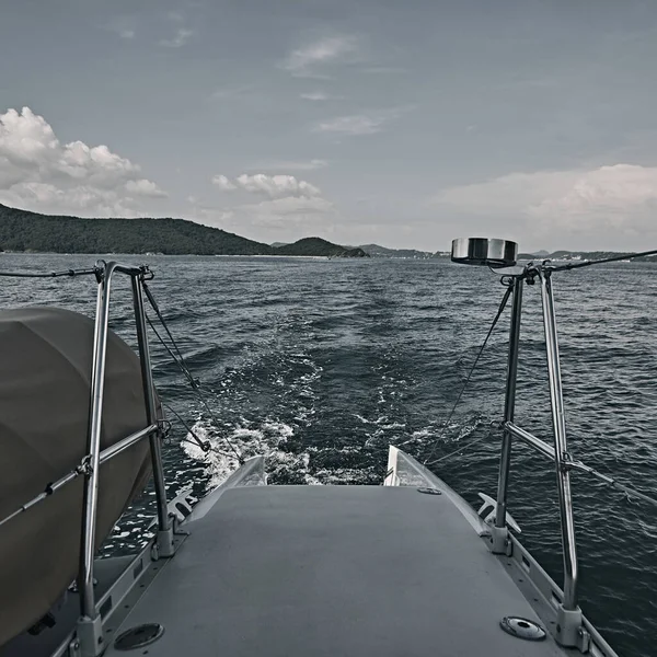 Boat in motion with foam wake behind the stern of fast moving