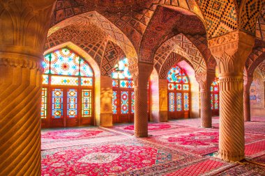 Famous pink mosque decorated with mosaic tiles and religious calligraphic scripts from Persian Islamic Quran, Shiraz, Iran.  clipart