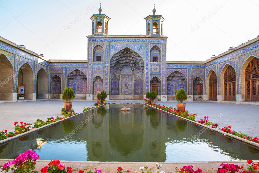 Famous pink mosque decorated with mosaic tiles and religious calligraphic scripts from Persian Islamic Quran, Shiraz, Iran. 