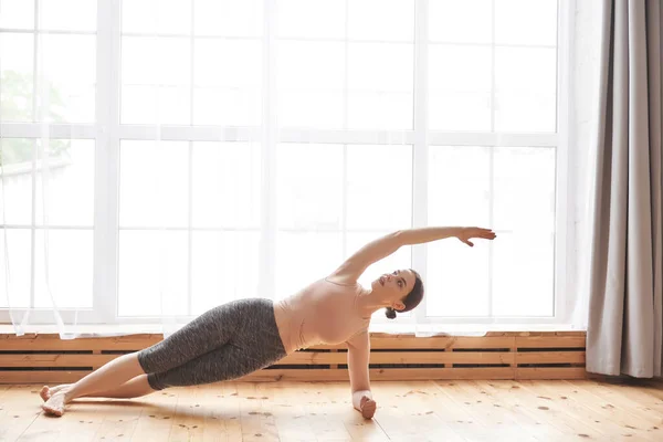 Ung Attraktiv Kvinna Sportkläder Utövar Yoga Stretching Kropp Stående Sidoplanka — Stockfoto