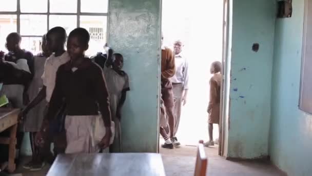 KISUMU, KENIA - 21 DE MAYO DE 2018: Grupo de niños en uniforme entra en clase y se prepara para la lección en la escuela en África . — Vídeos de Stock